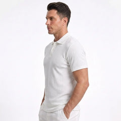 Man wearing MannerCo white jacquard knit polo shirt, side view on plain background