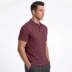 Man wearing MannerCo wine red jacquard knit polo shirt in outdoor lifestyle setting