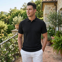 Man wearing MannerCo wine red jacquard knit polo shirt in outdoor lifestyle setting