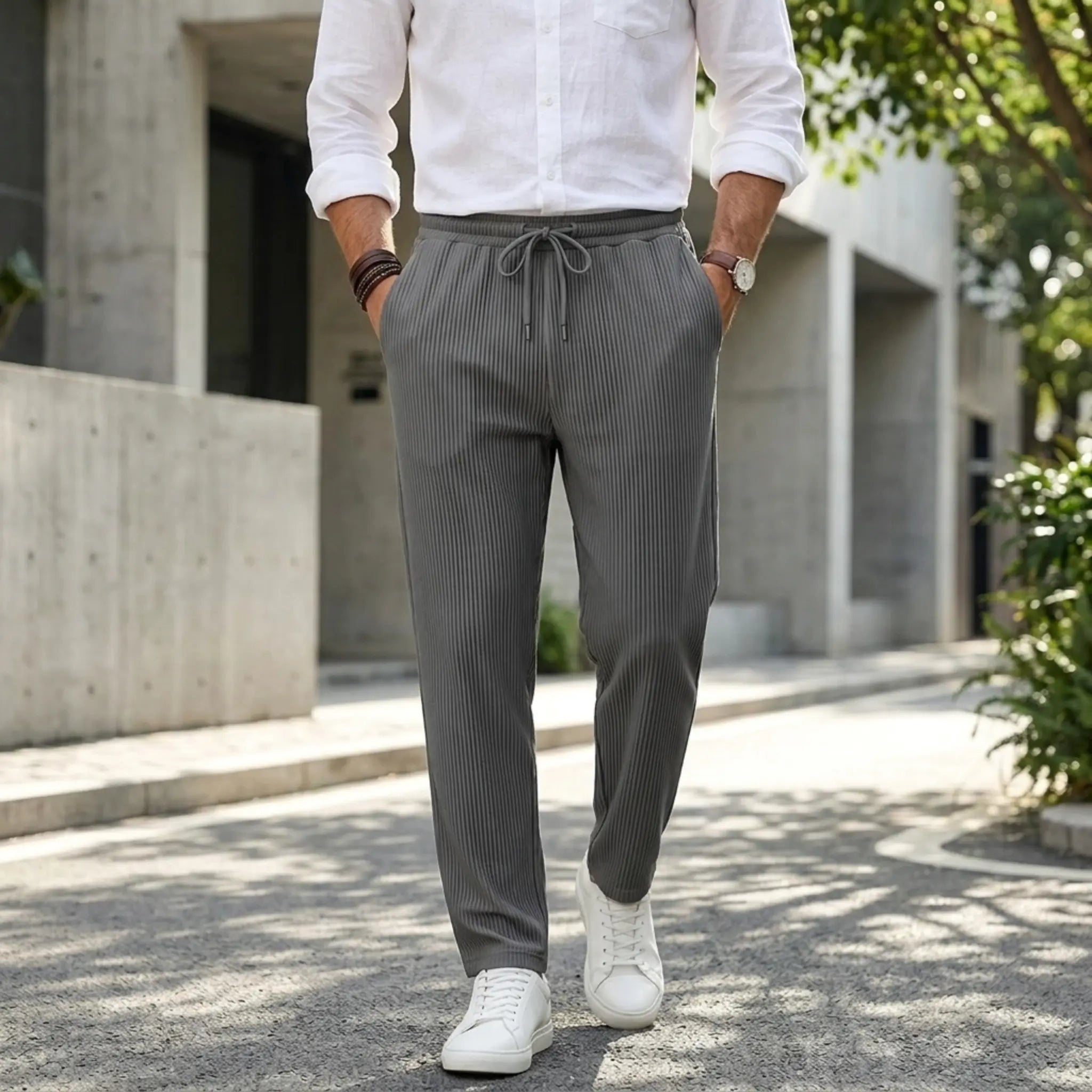 Man wearing MannerCo army green jacquard ribbed straight leg drawstring trousers, back view on plain background