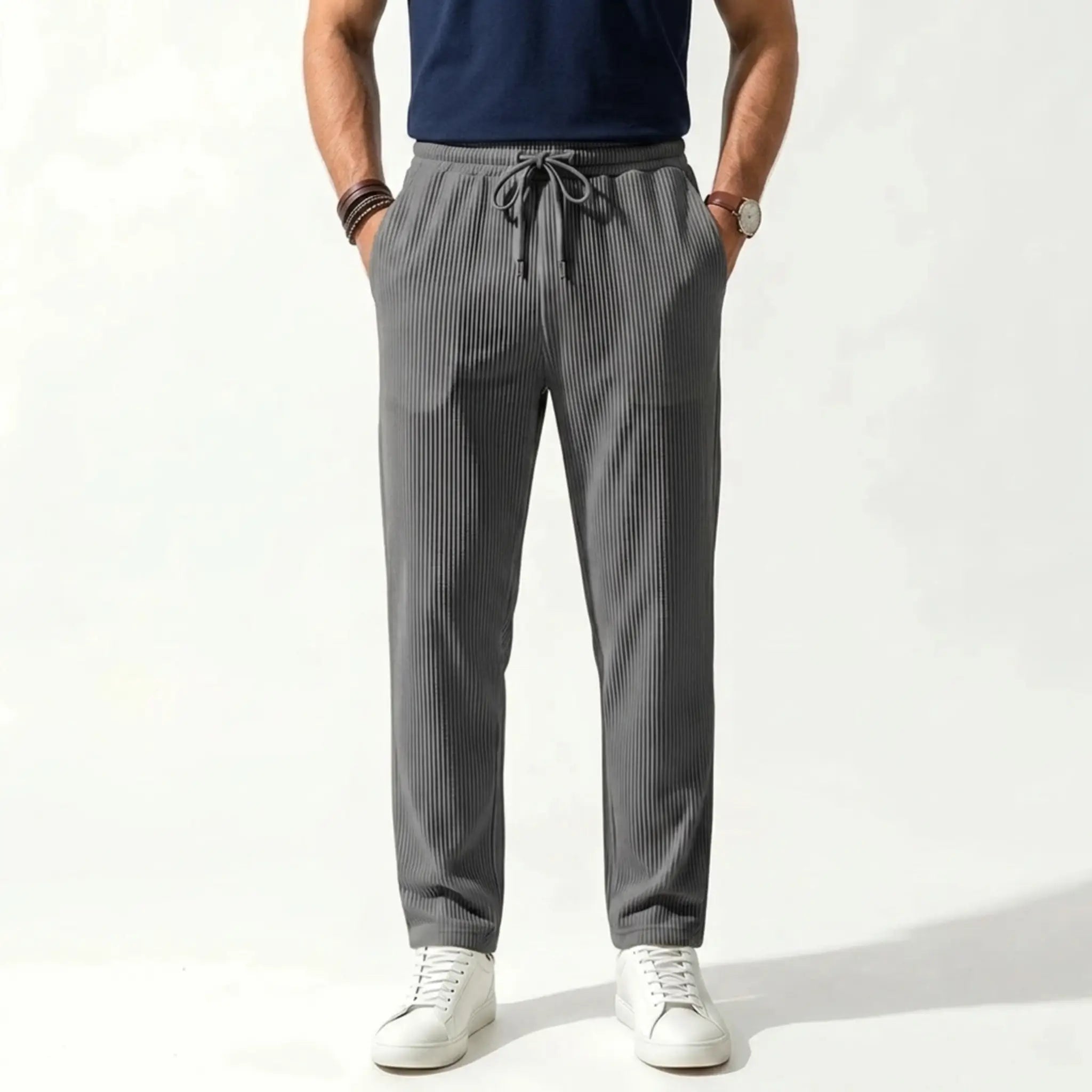 Man wearing MannerCo army green jacquard ribbed straight leg drawstring trousers, front view on plain background