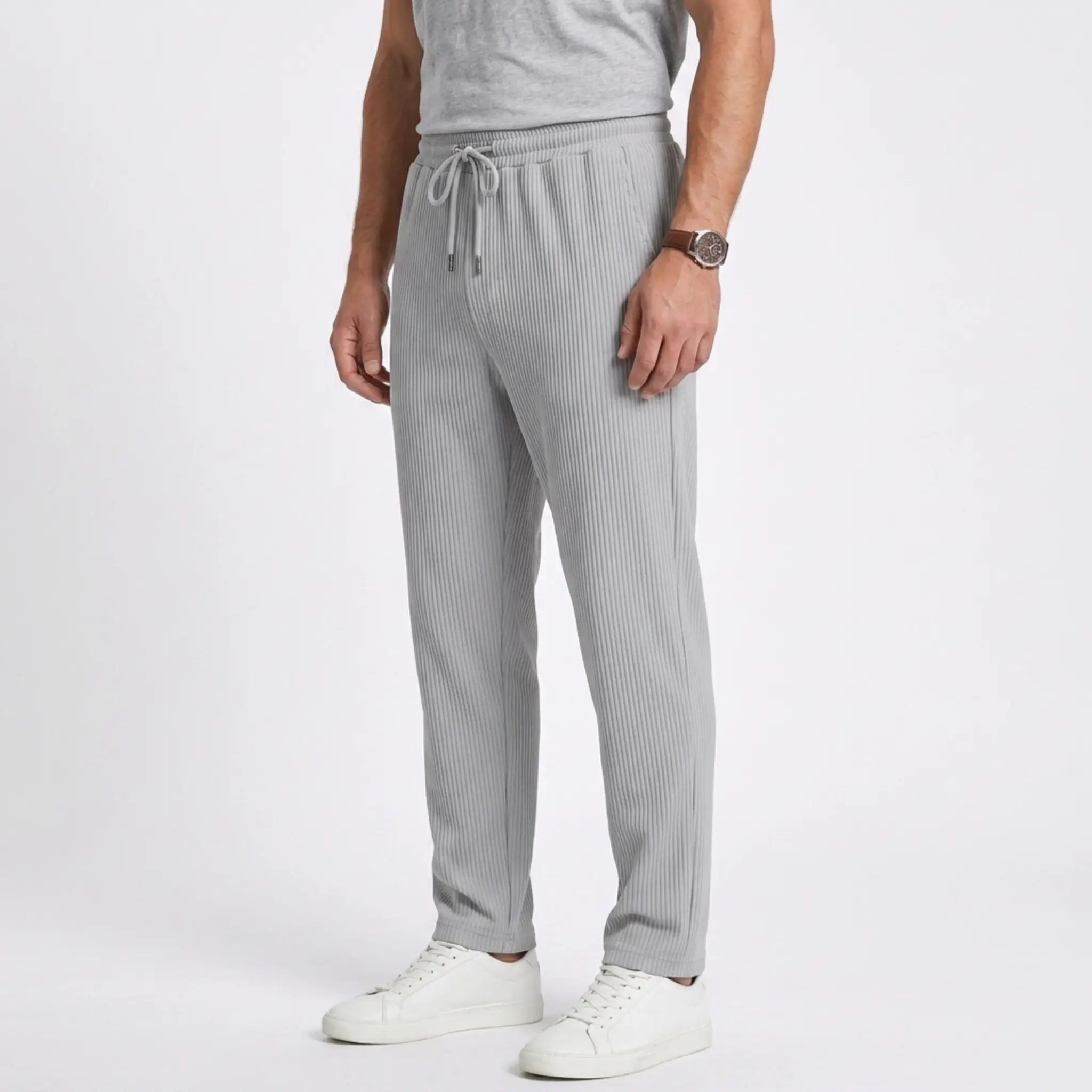 Man wearing MannerCo black jacquard ribbed straight leg drawstring trousers in outdoor lifestyle setting