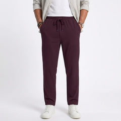 Man wearing MannerCo black jacquard ribbed drawstring trousers in outdoor lifestyle setting