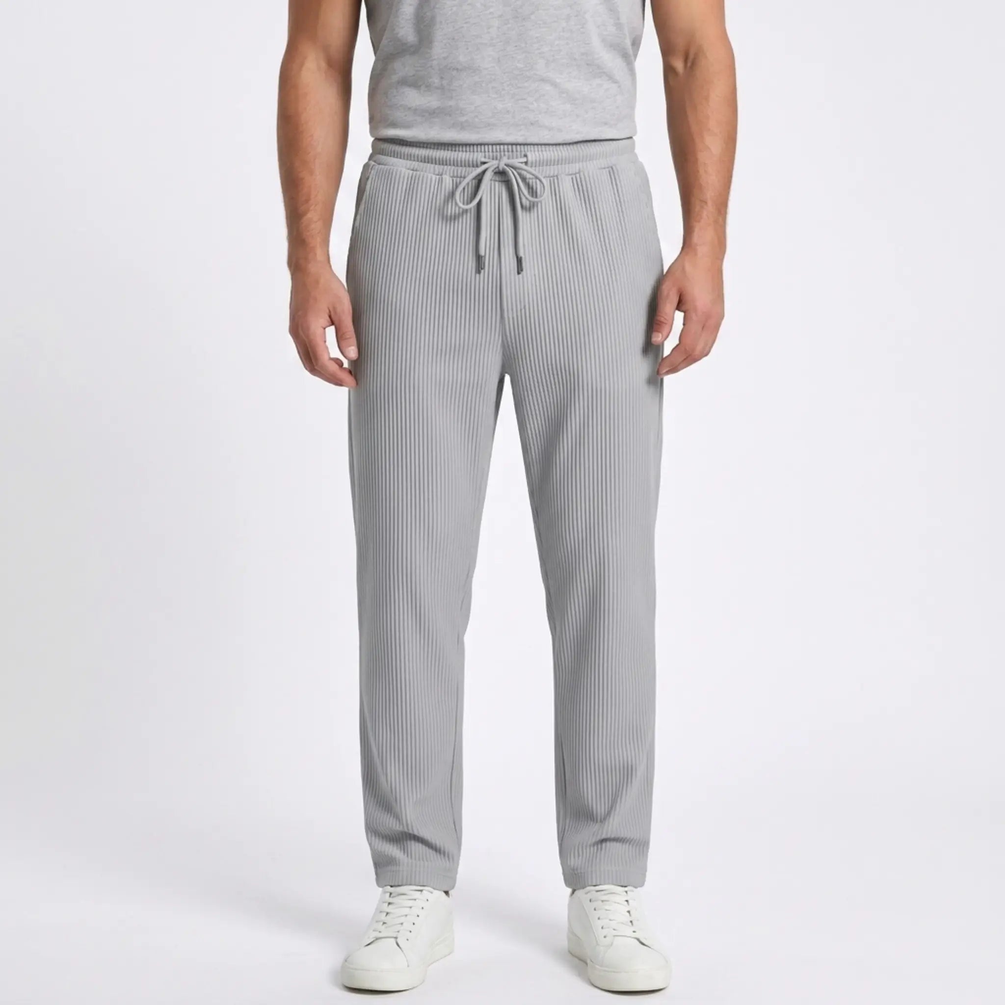 Man wearing MannerCo black jacquard ribbed drawstring trousers in outdoor lifestyle setting