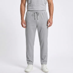 Man wearing MannerCo black jacquard ribbed drawstring trousers in outdoor lifestyle setting