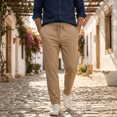 Man wearing MannerCo dark gray jacquard ribbed straight leg drawstring trousers, back view on plain background