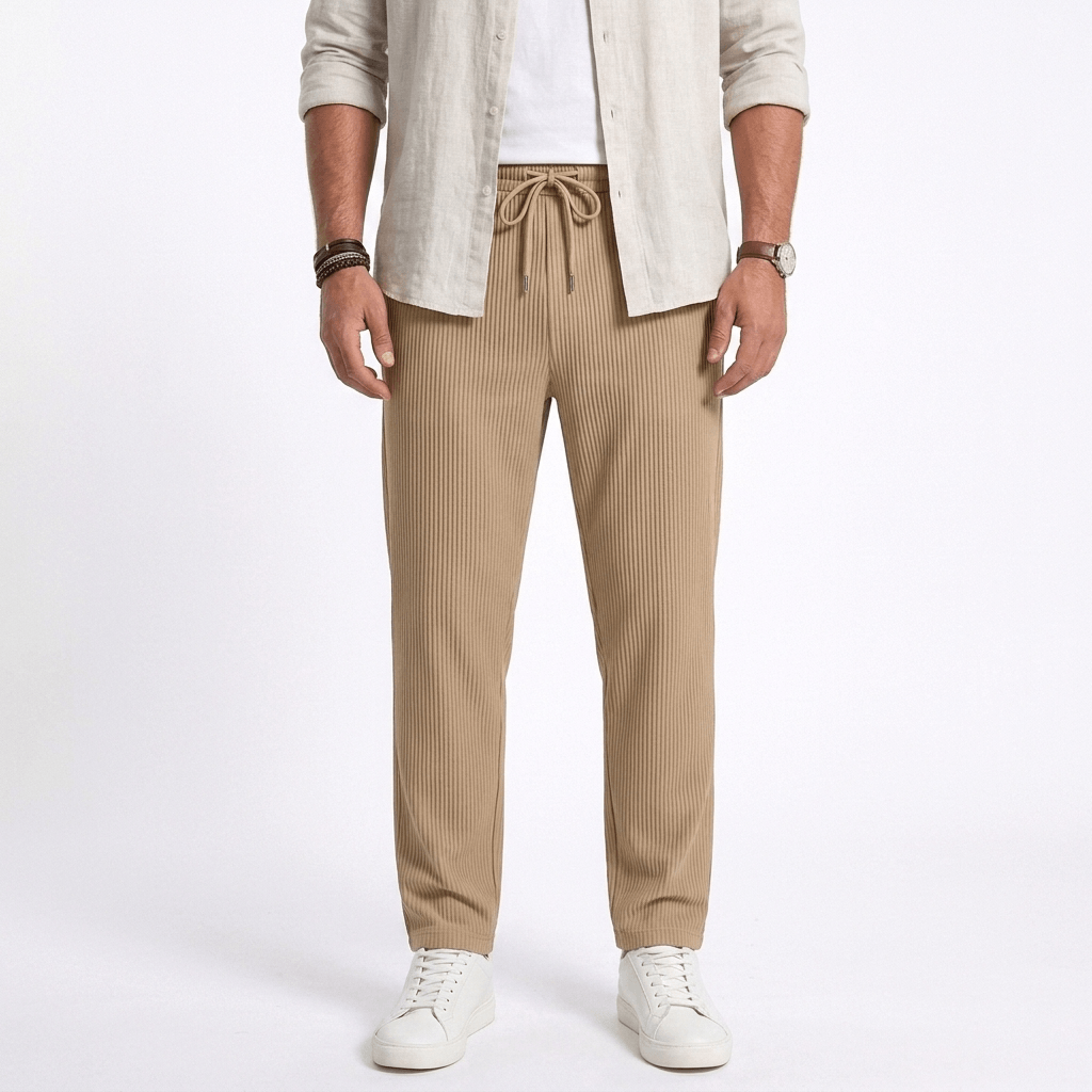 Man wearing MannerCo dark gray jacquard ribbed straight leg drawstring trousers, front view on plain background