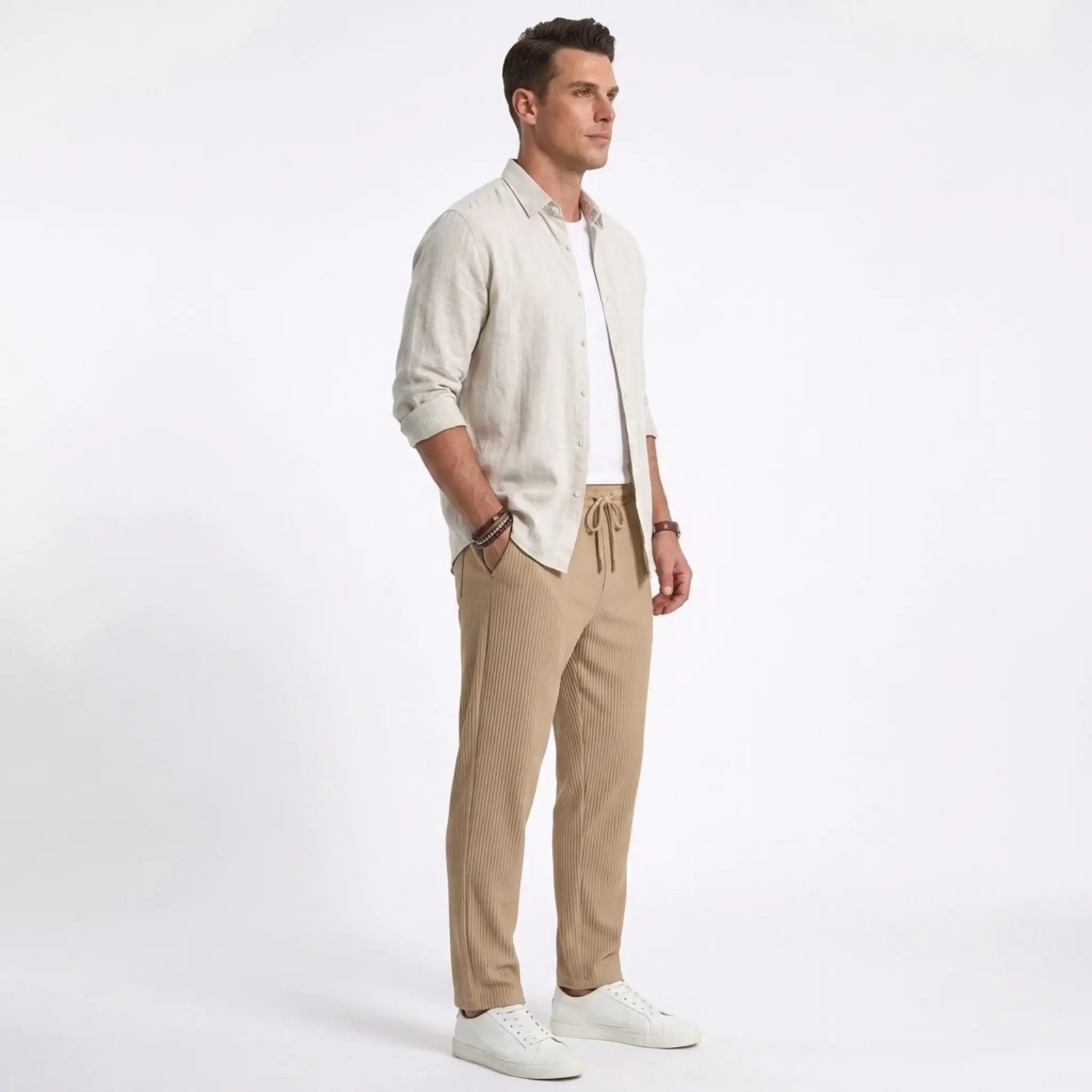 Man wearing MannerCo dark gray jacquard ribbed drawstring trousers in outdoor lifestyle setting