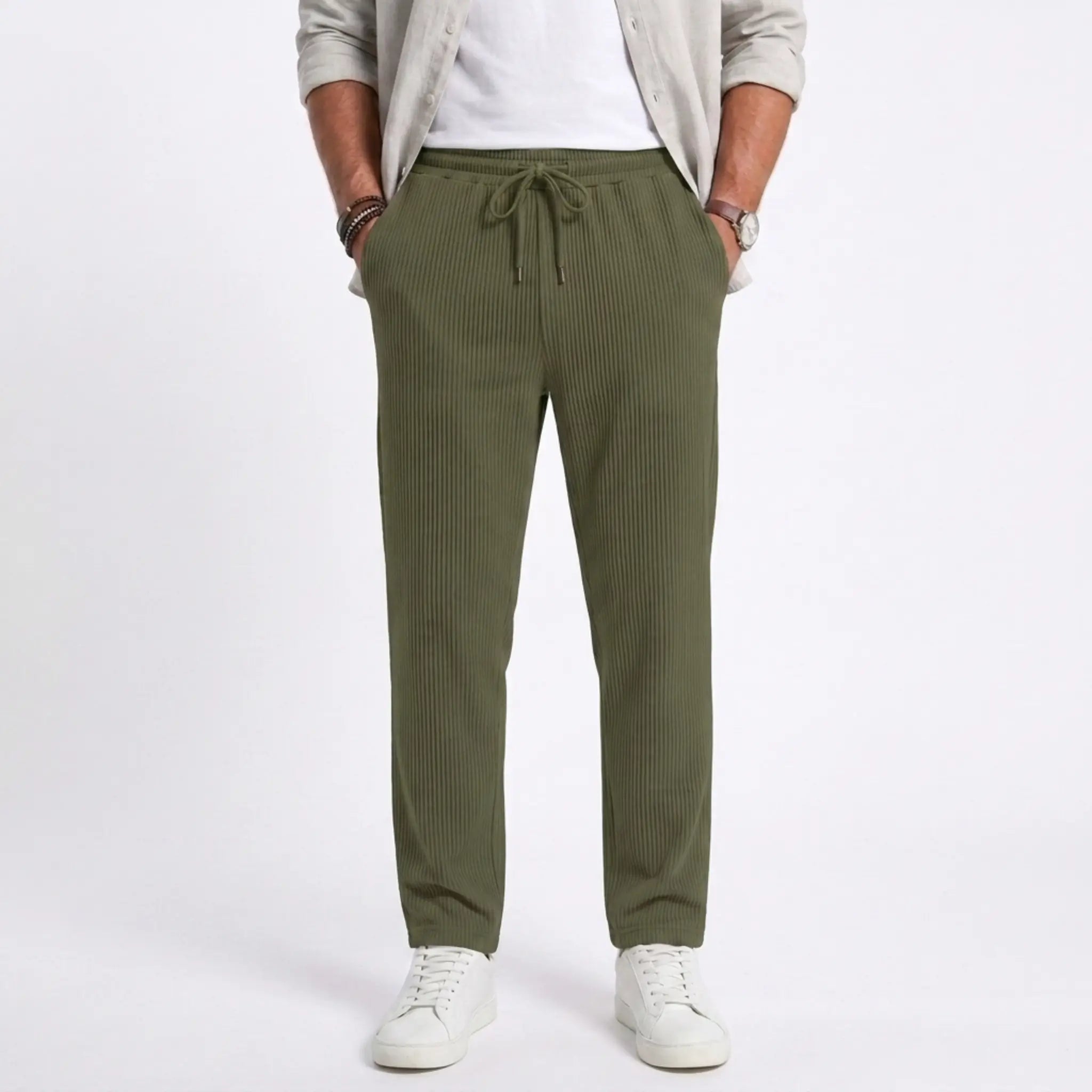 Man wearing MannerCo light gray jacquard ribbed straight leg drawstring trousers in outdoor lifestyle setting