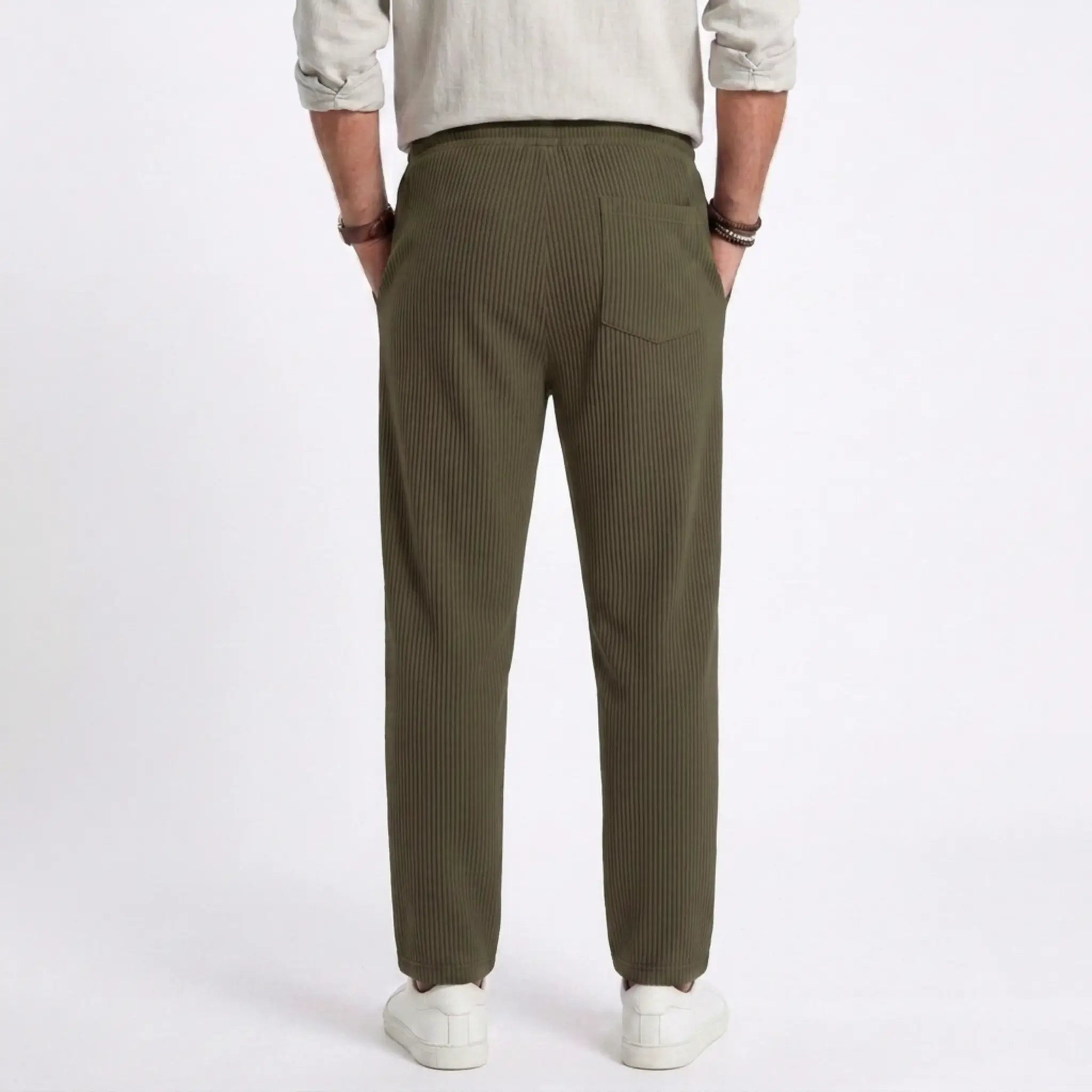 Man wearing MannerCo light gray jacquard ribbed drawstring trousers outdoors in urban setting