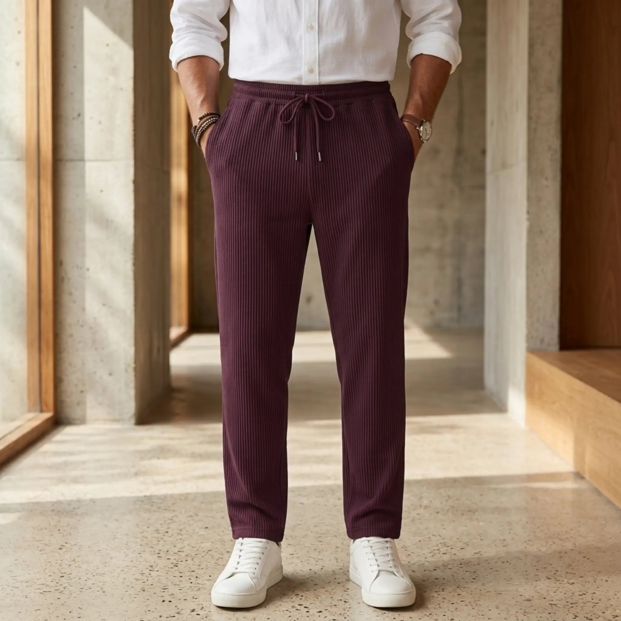 Man wearing MannerCo light gray jacquard ribbed drawstring trousers in outdoor lifestyle setting