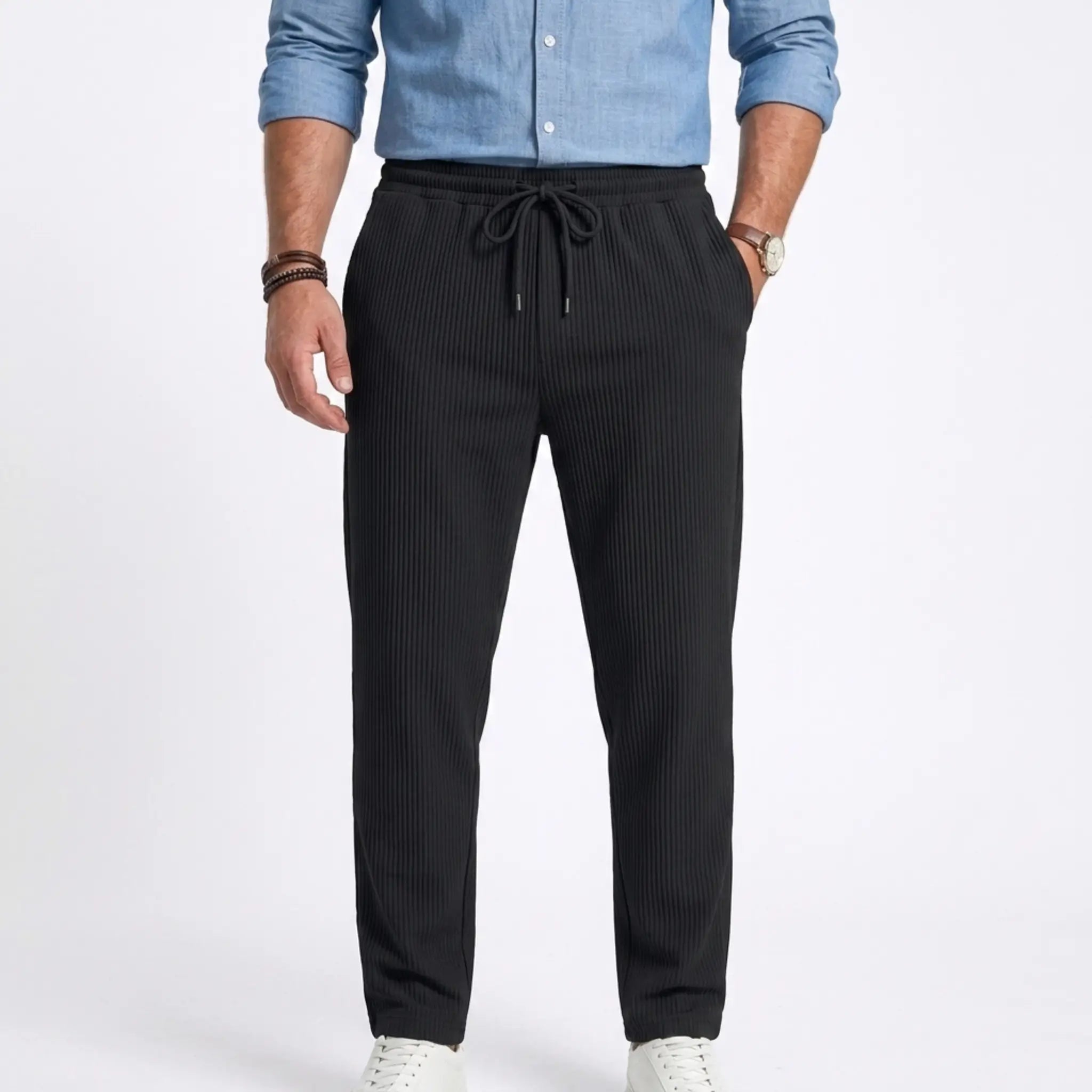Man wearing MannerCo white jacquard ribbed drawstring trousers, back view on plain background