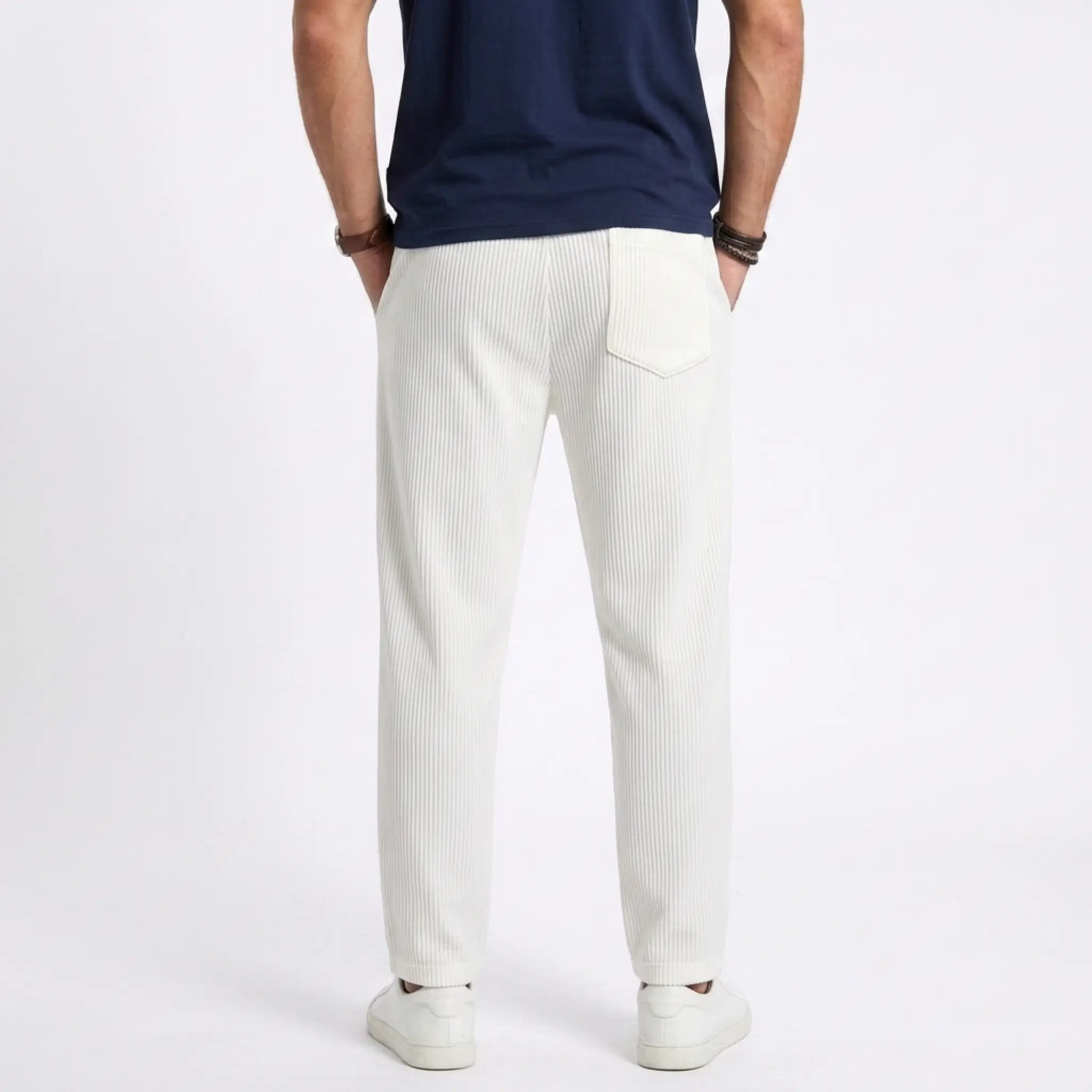 Man wearing MannerCo white jacquard ribbed drawstring trousers in outdoor lifestyle setting