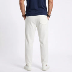 Man wearing MannerCo white jacquard ribbed drawstring trousers in outdoor lifestyle setting