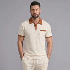 Man wearing a khaki color block waffle polo shirt and straight leg pants front view on plain background