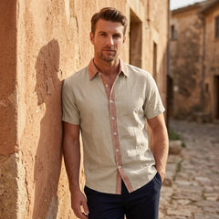 MannerCo khaki linen blend short sleeve shirt with contrast collar, worn by man in rustic outdoor setting