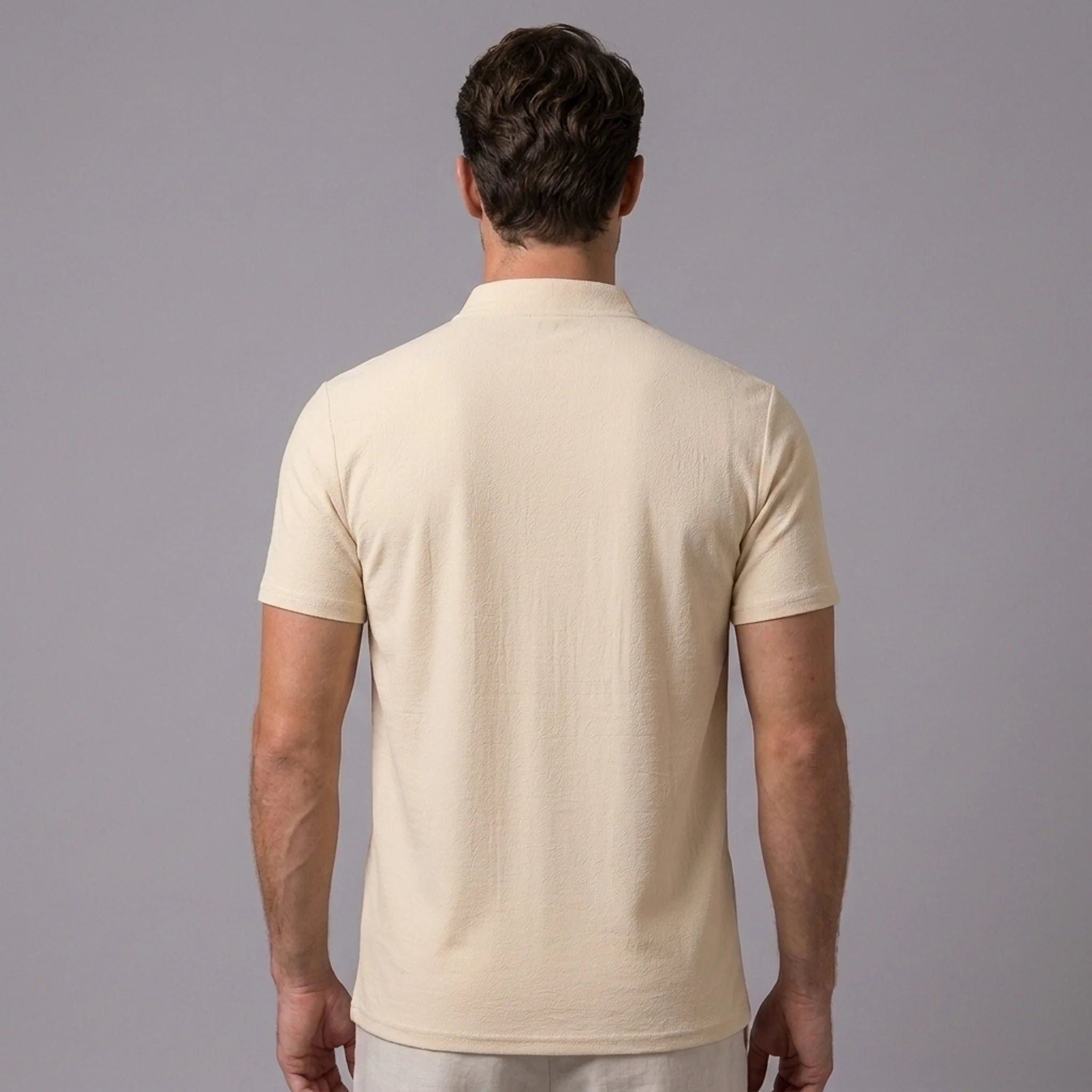 Back view of man wearing khaki linen jacquard short sleeve polo shirt