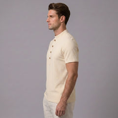 Side view of man in khaki linen jacquard short sleeve polo shirt on plain background