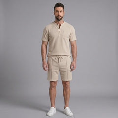 Back view of man wearing khaki waffle stand collar shirt and drawstring shorts