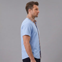 MannerCo light blue linen blend short sleeve shirt with contrast collar, side view on male model