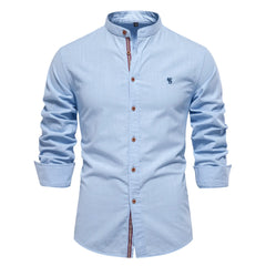 MannerCo light blue linen stand collar long sleeve shirt with brown buttons and stripe placket