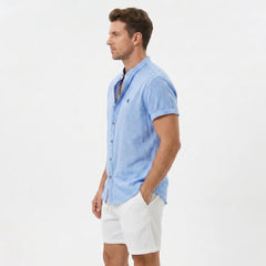 Side view of man in light blue linen look stand collar shirt and crinkle textured drawstring shorts