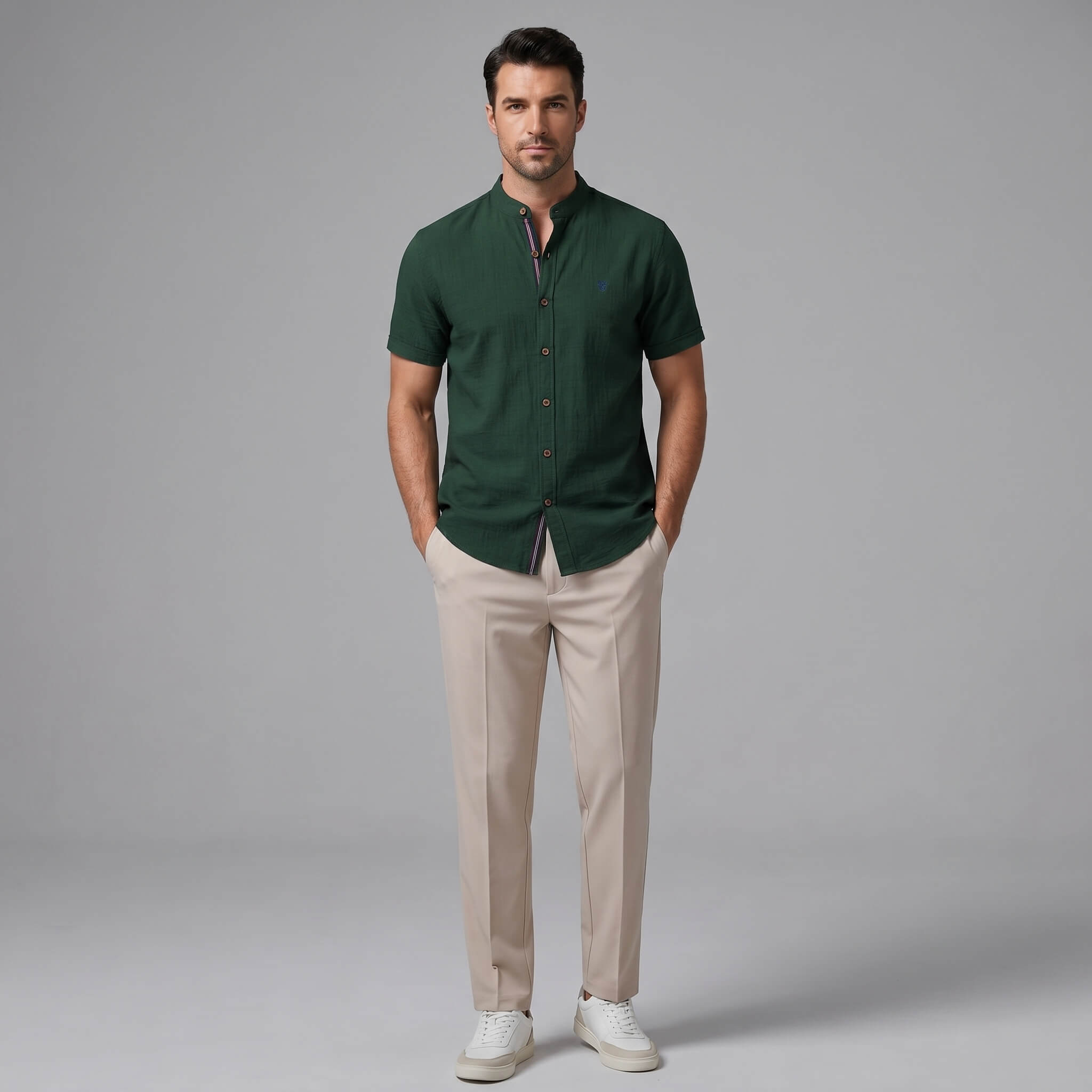Man wearing a light blue linen look stand collar shirt and slim fit tapered trousers front view on plain background