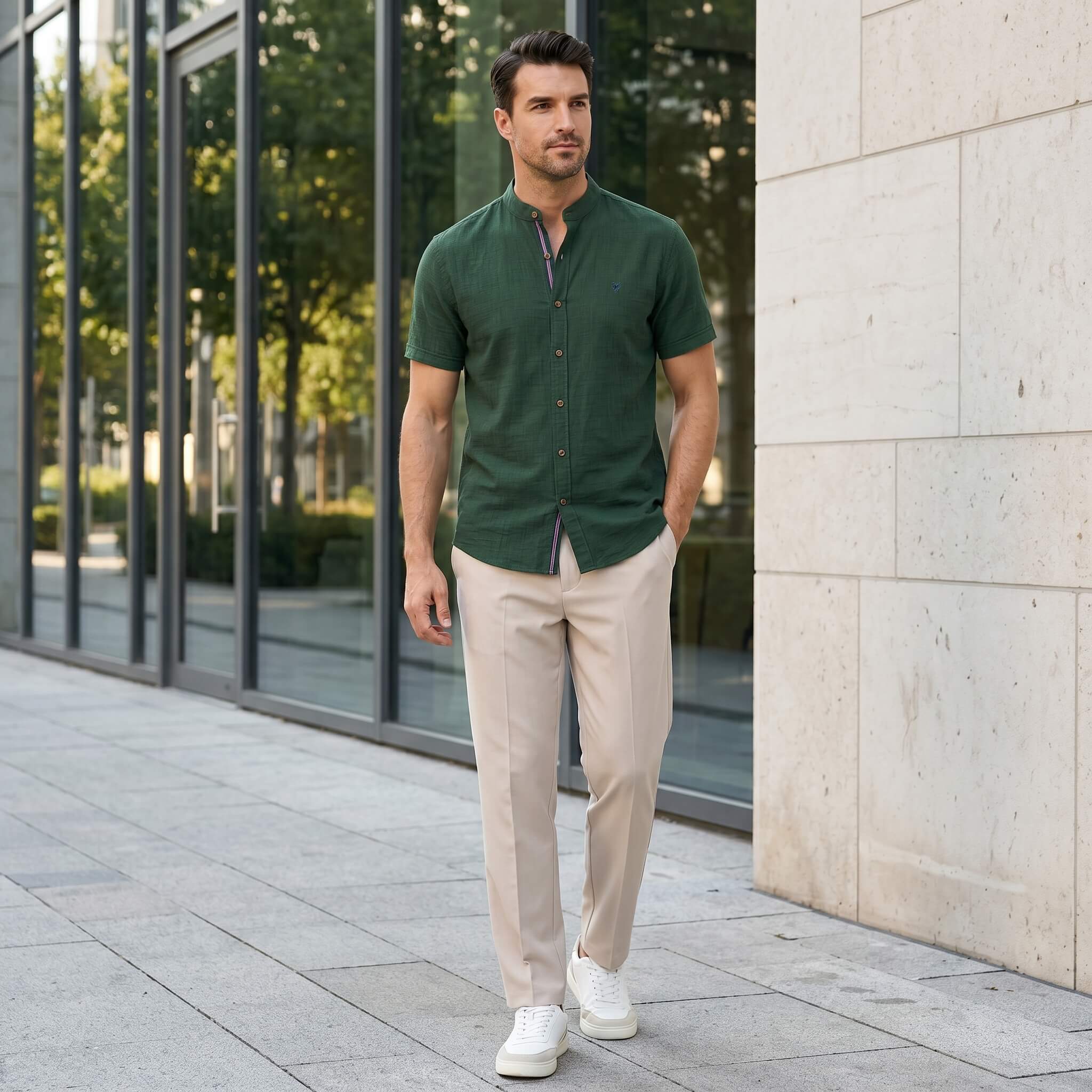 Man in light blue linen look stand collar shirt and slim tapered trousers in sunny outdoor summer scene