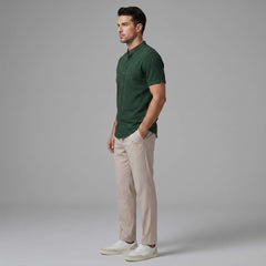 Side view of man in light blue linen look stand collar shirt and slim fit tapered trousers
