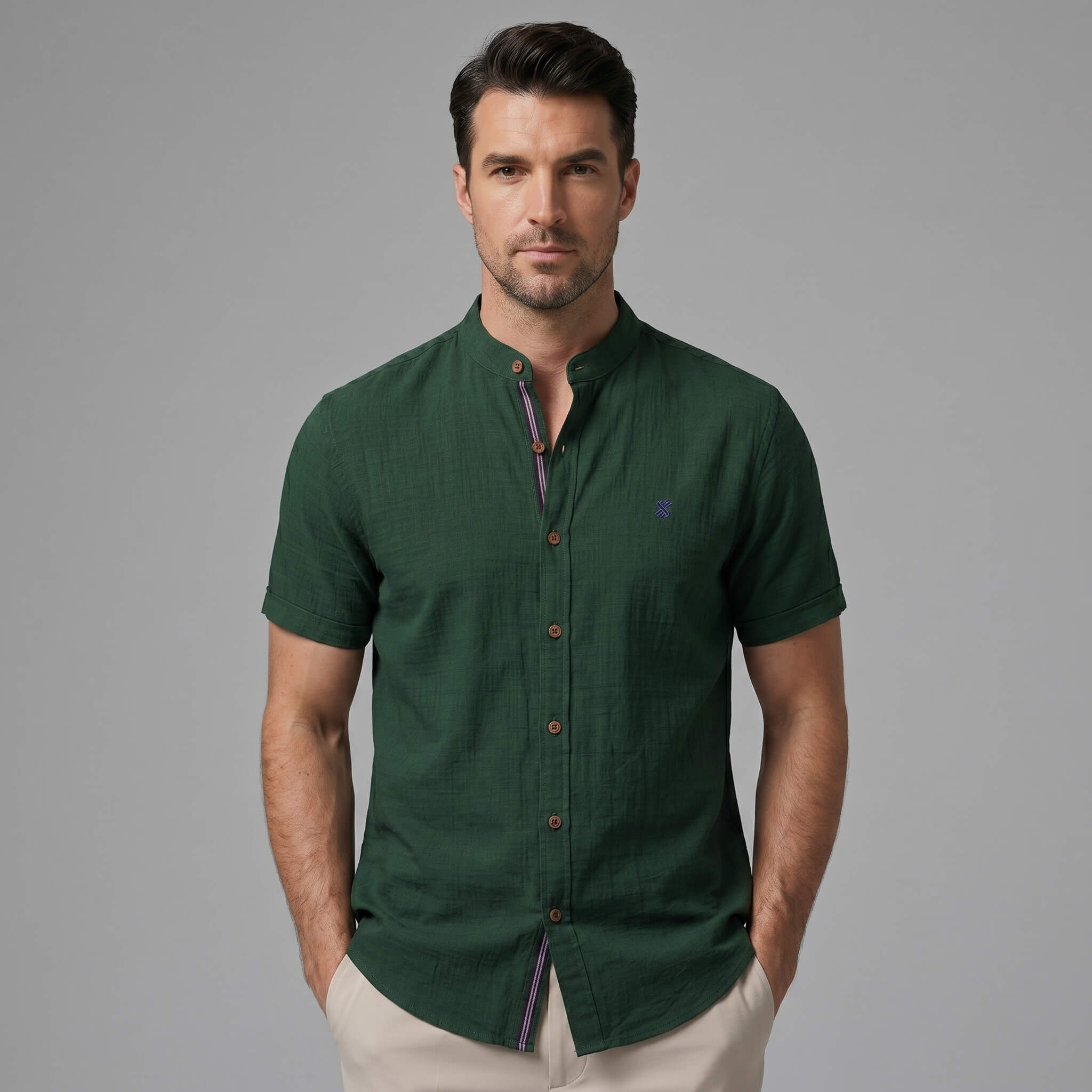Three quarter view of man in light blue linen look stand collar shirt and slim tapered trousers