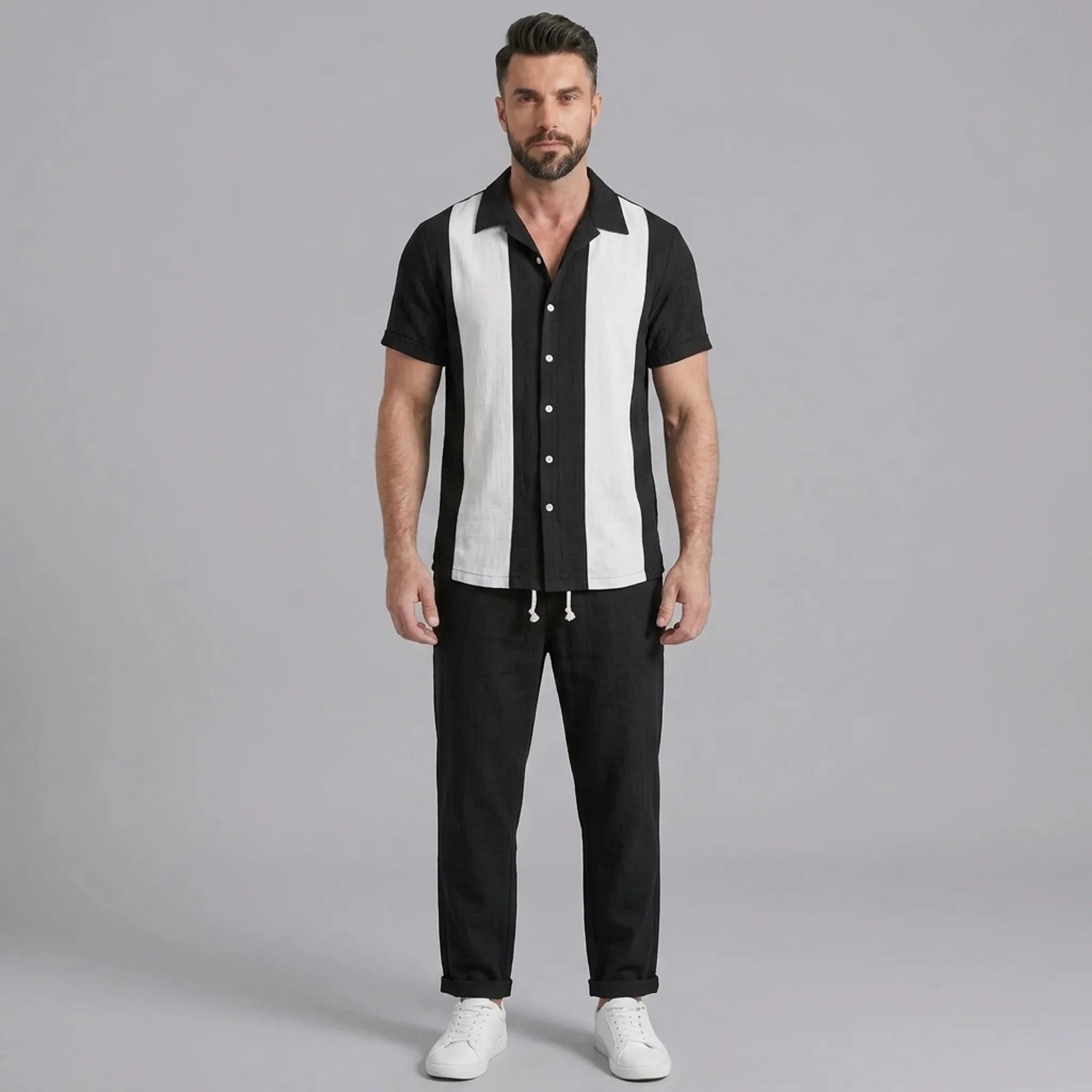 Man wearing light blue patchwork bowling shirt and linen pants in outdoor lifestyle setting