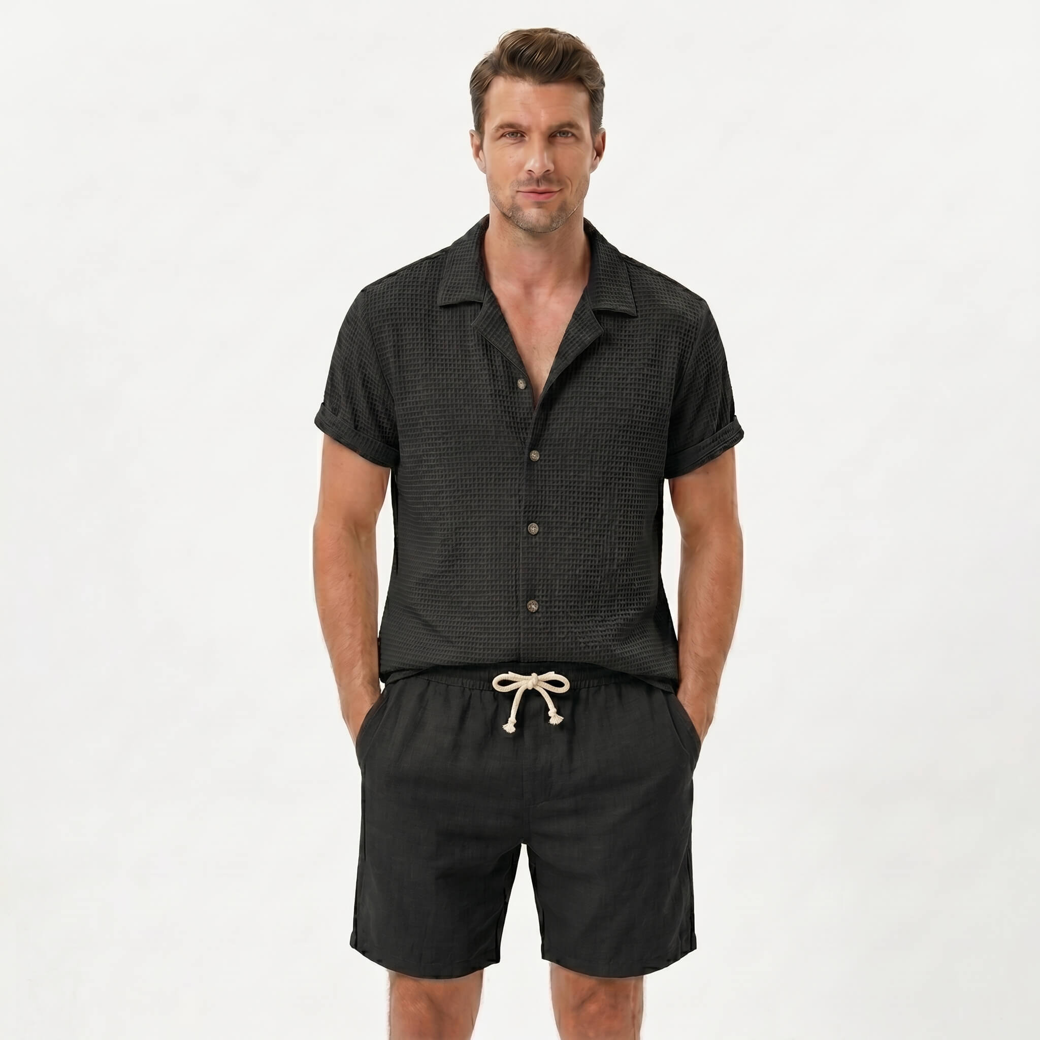 Man in light blue textured Cuban shirt and linen drawstring shorts in sunny outdoor summer scene