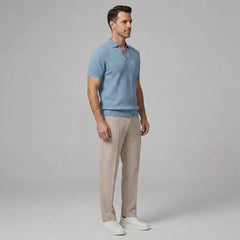 Man wearing a light blue waffle johnny collar polo shirt and slim fit tapered pants front view