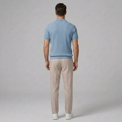Side view of man in light blue waffle johnny collar polo and slim fit tapered pants