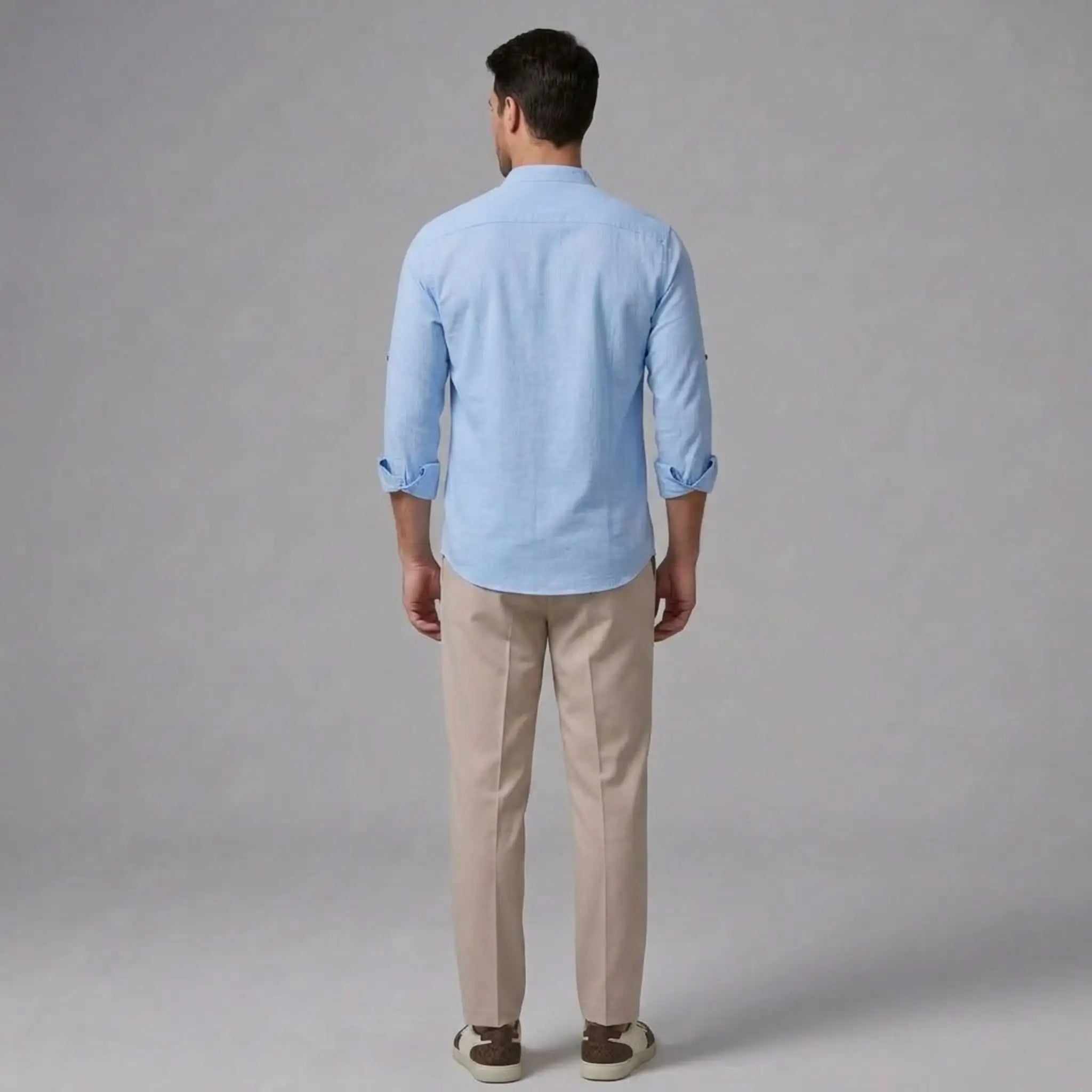 MannerCo light blue linen stand collar shirt with slim tapered beige trousers back view