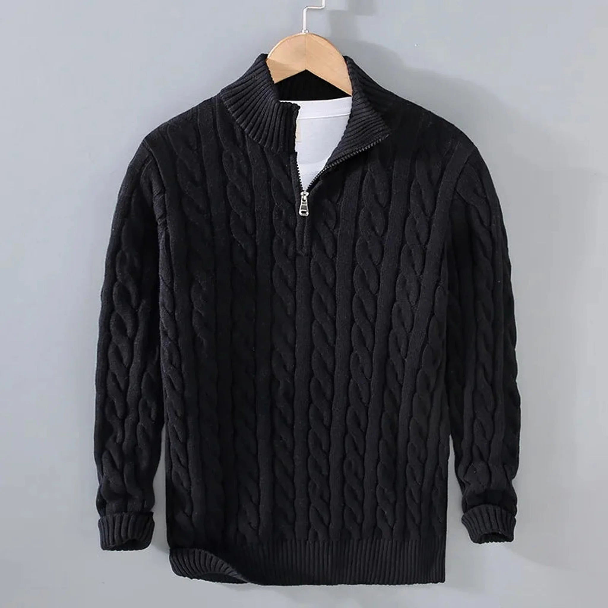 Black cable knit quarter-zip sweater, front view on hanger