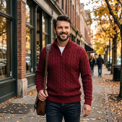 Man wearing burgundy cable knit quarter-zip sweater on a city street