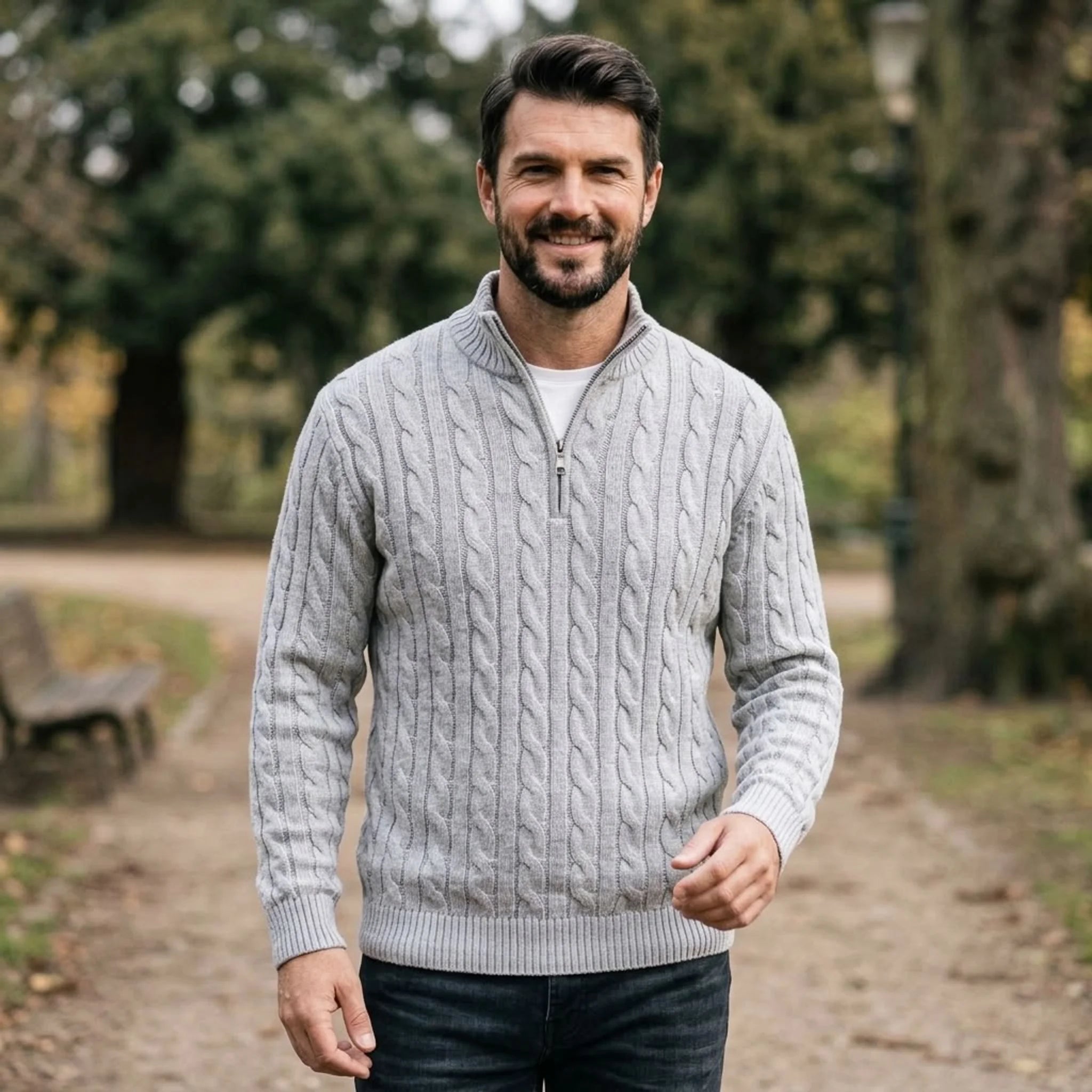 Man wearing light grey cable knit quarter-zip sweater in a park