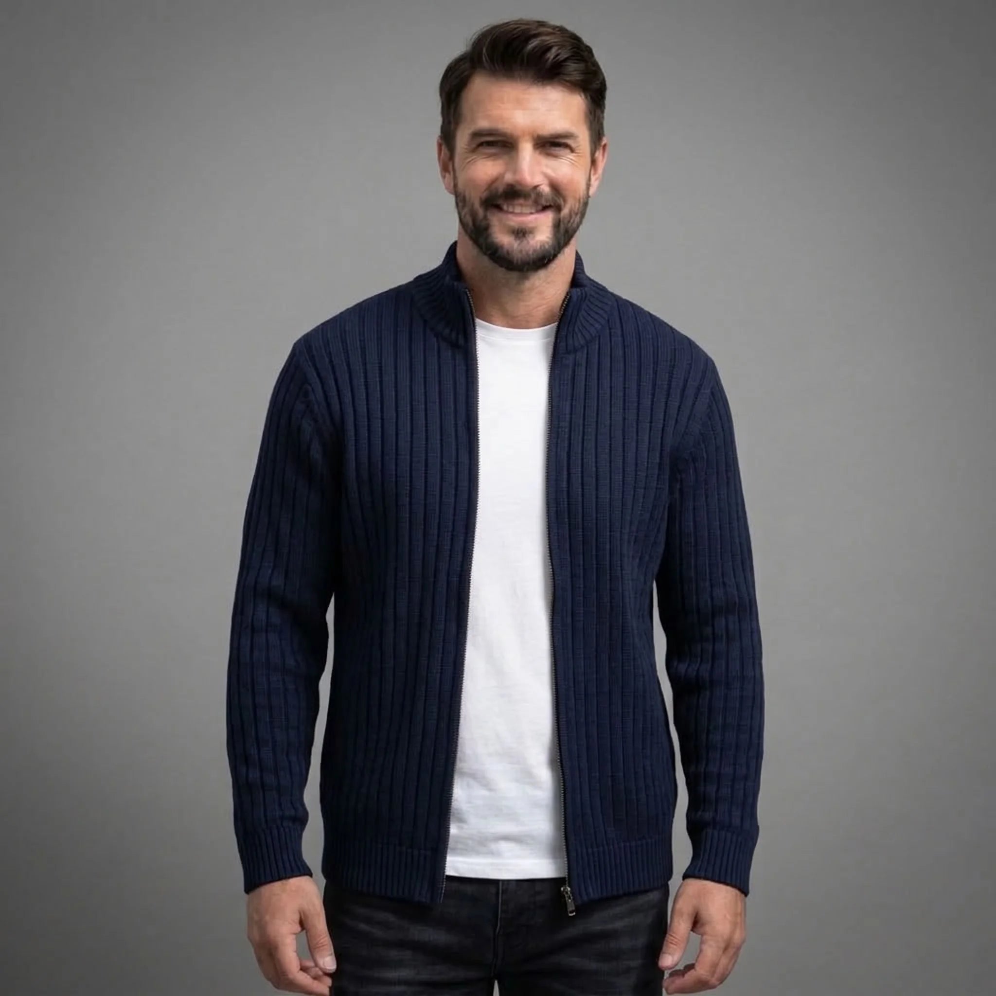 Navy cable knit full-zip sweater worn open over a white tee