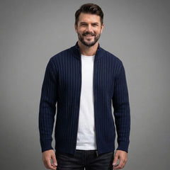 Navy cable knit full-zip sweater worn open over a white tee