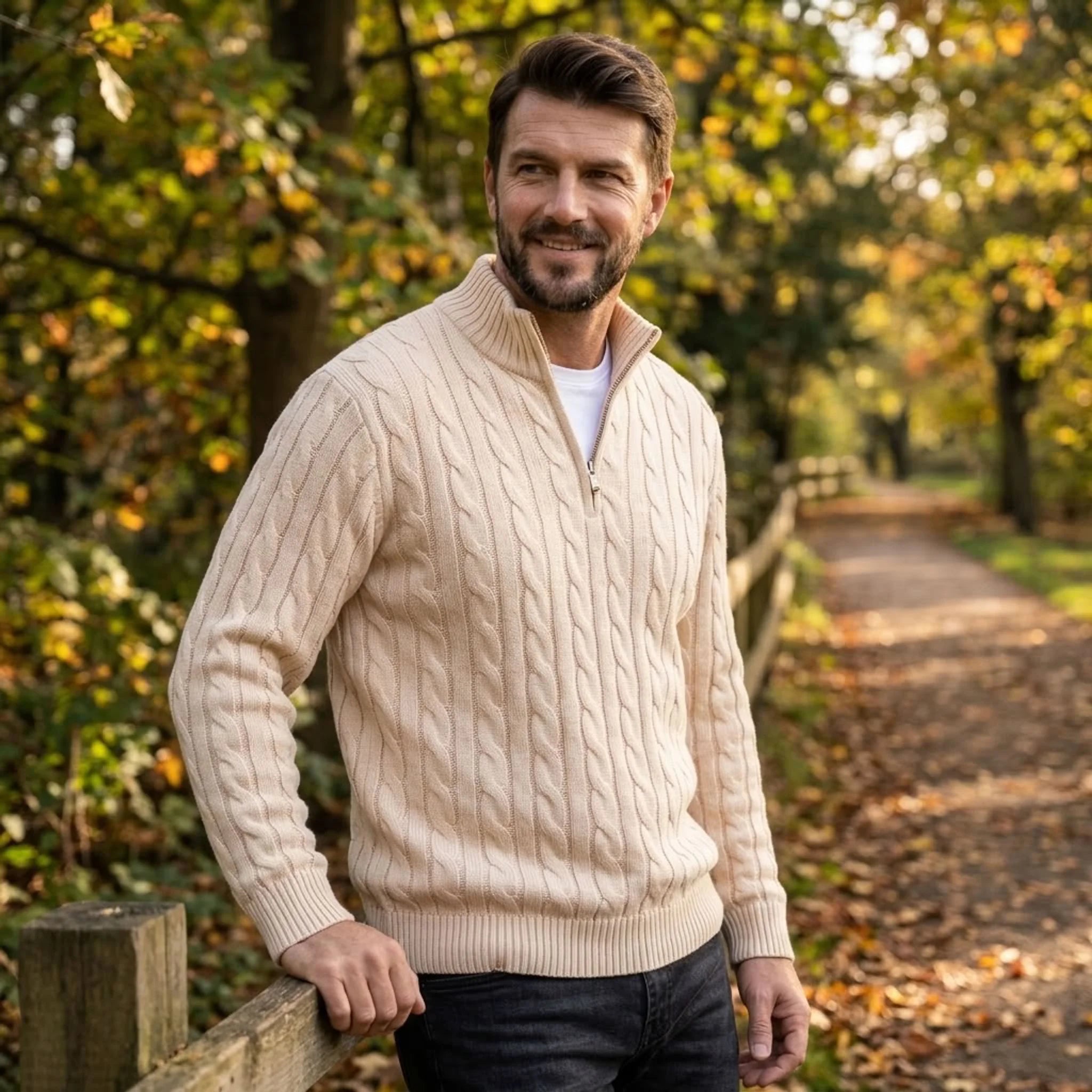 Man wearing sand cable knit quarter-zip sweater in an autumn park