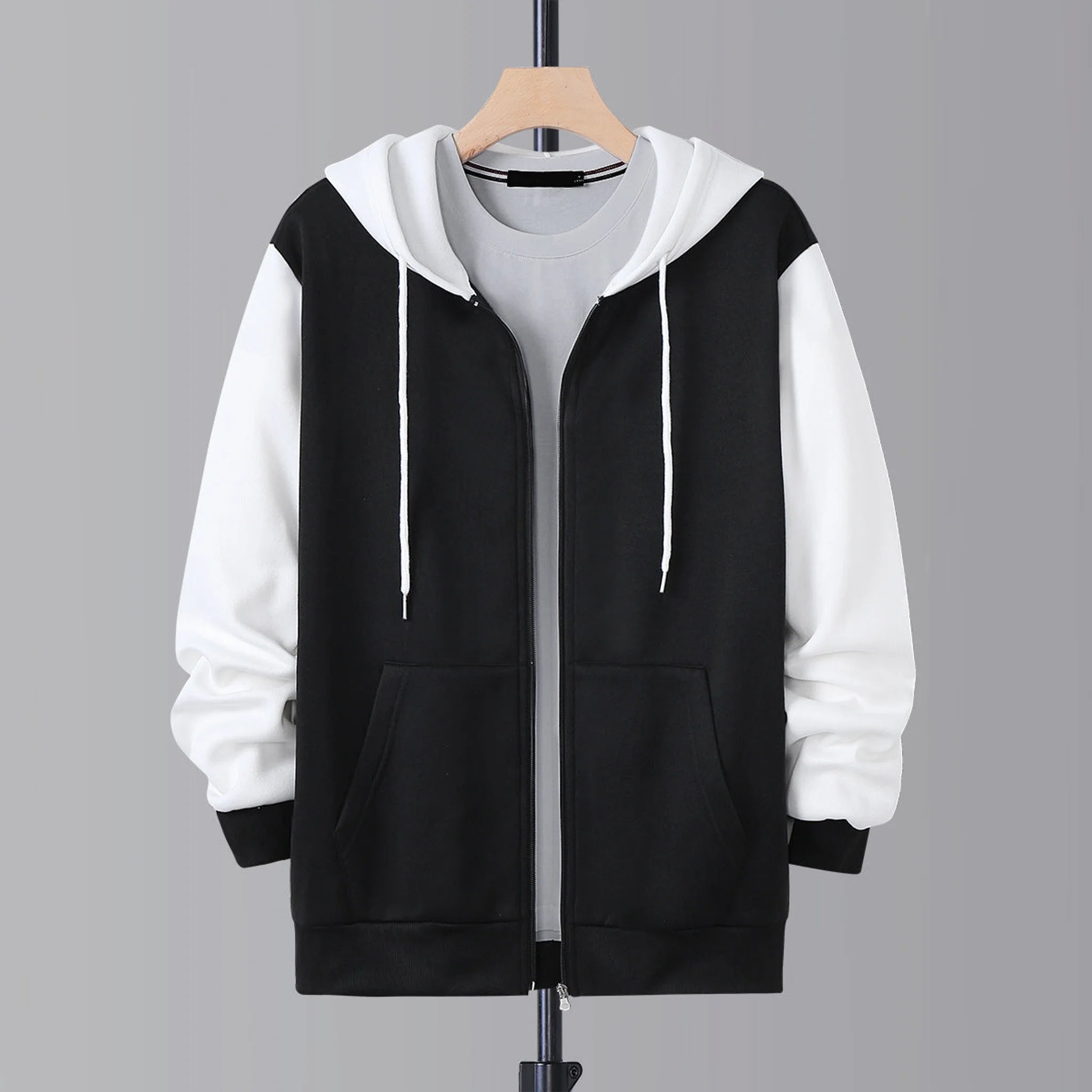 Black and white zip-up hoodie with white drawstring hood, product front