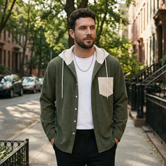 Man in army green corduroy hooded shirt jacket on a city street
