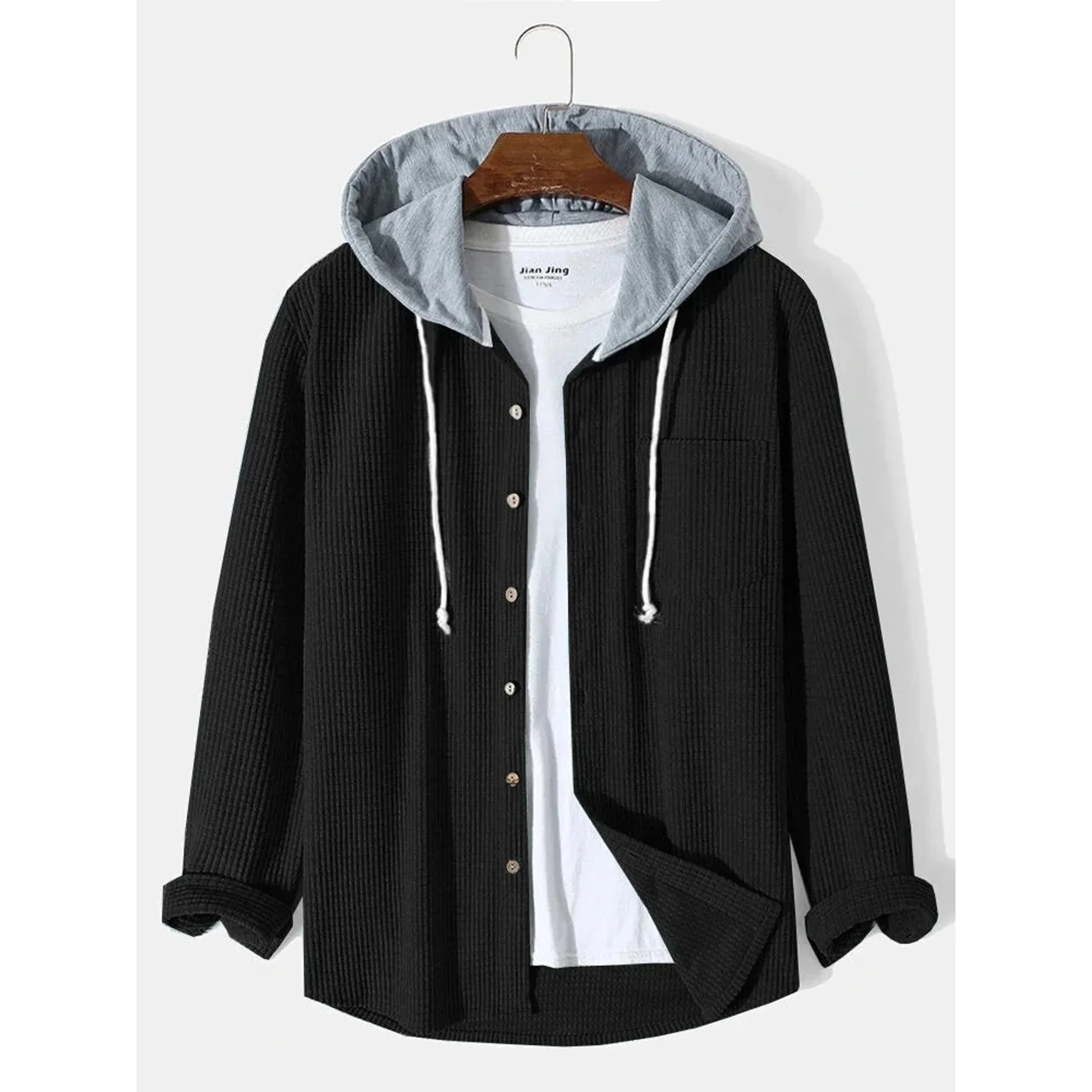 Black corduroy hooded overshirt on a hanger, front