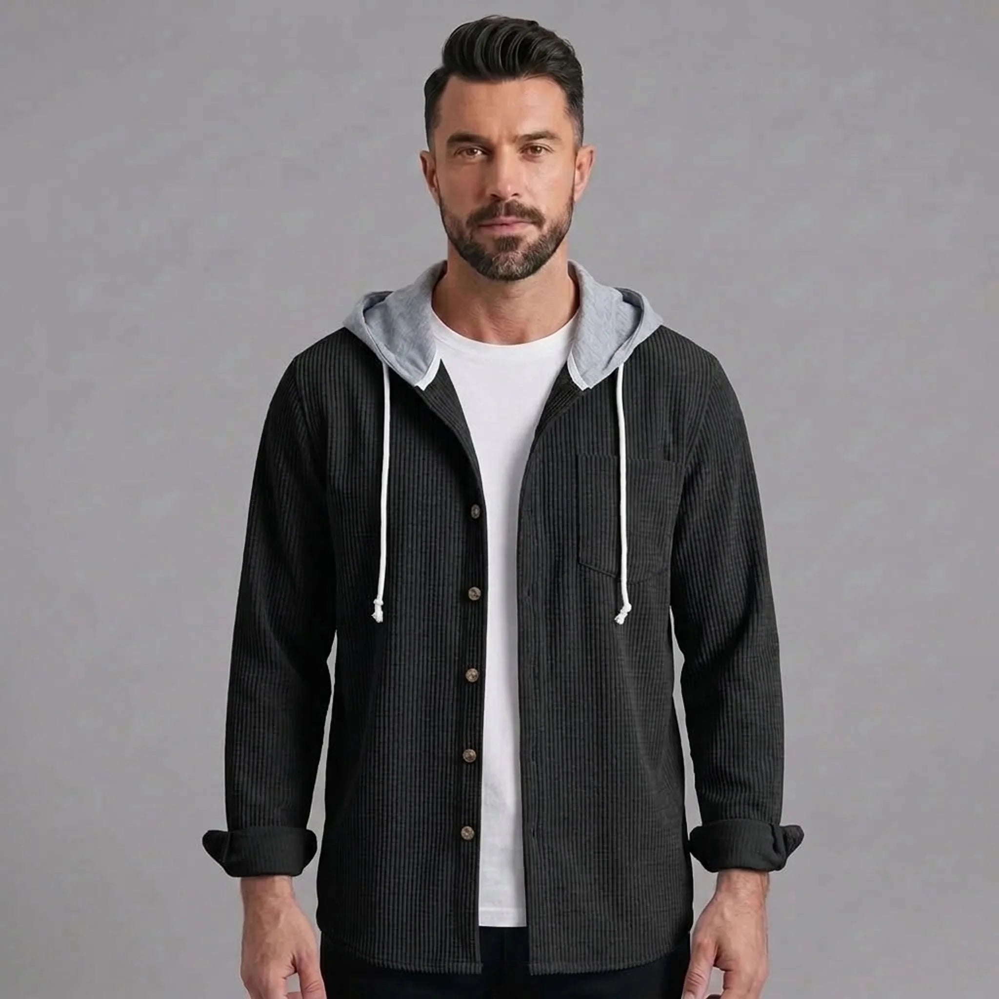 Man wearing black corduroy hooded shirt jacket, front view