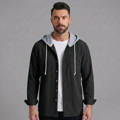 Man wearing black corduroy hooded shirt jacket, front view