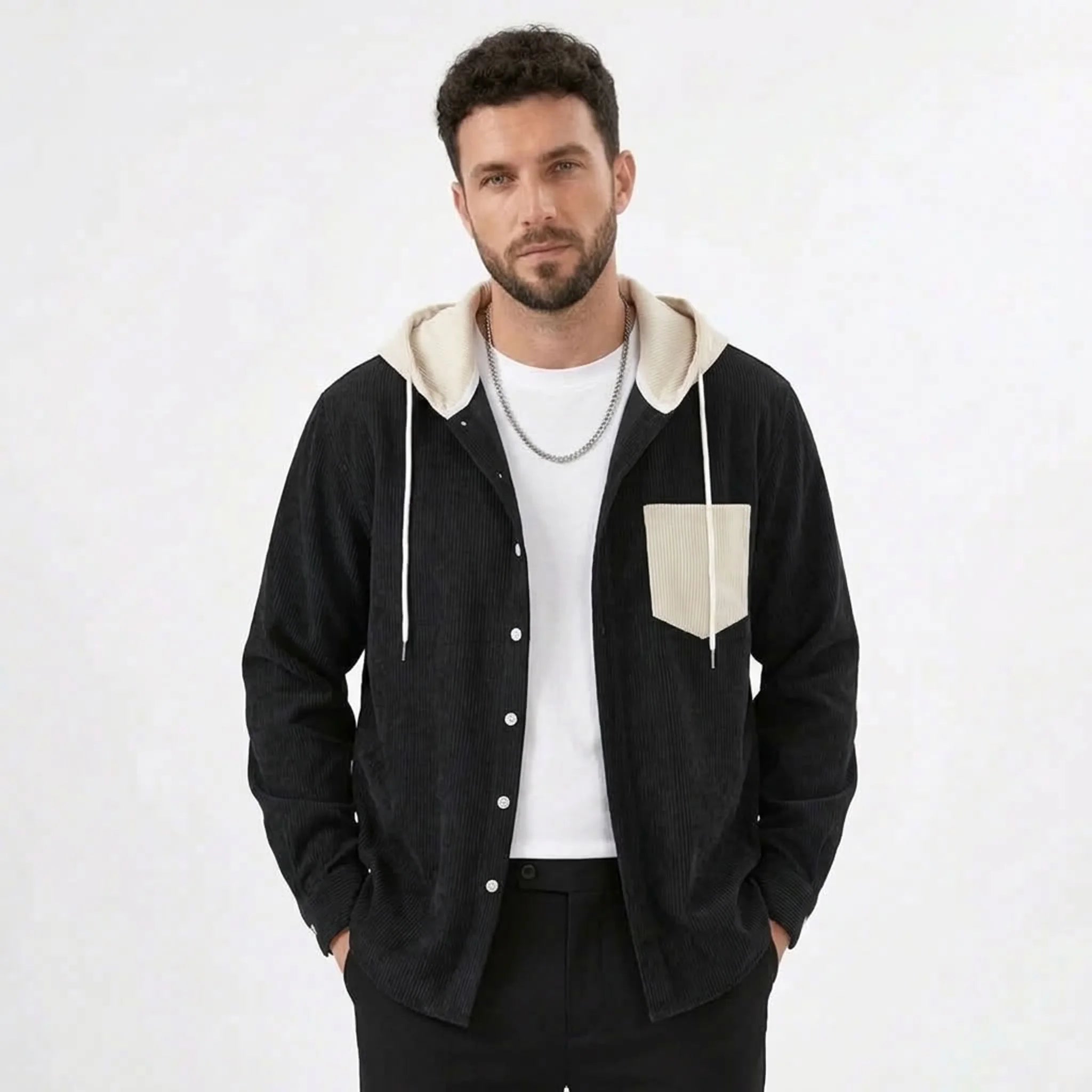 Black corduroy hooded shirt jacket with cream contrast hood, model front view