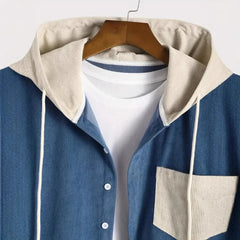 Denim blue corduroy shirt jacket, close-up of cream drawstring hood and chest pocket