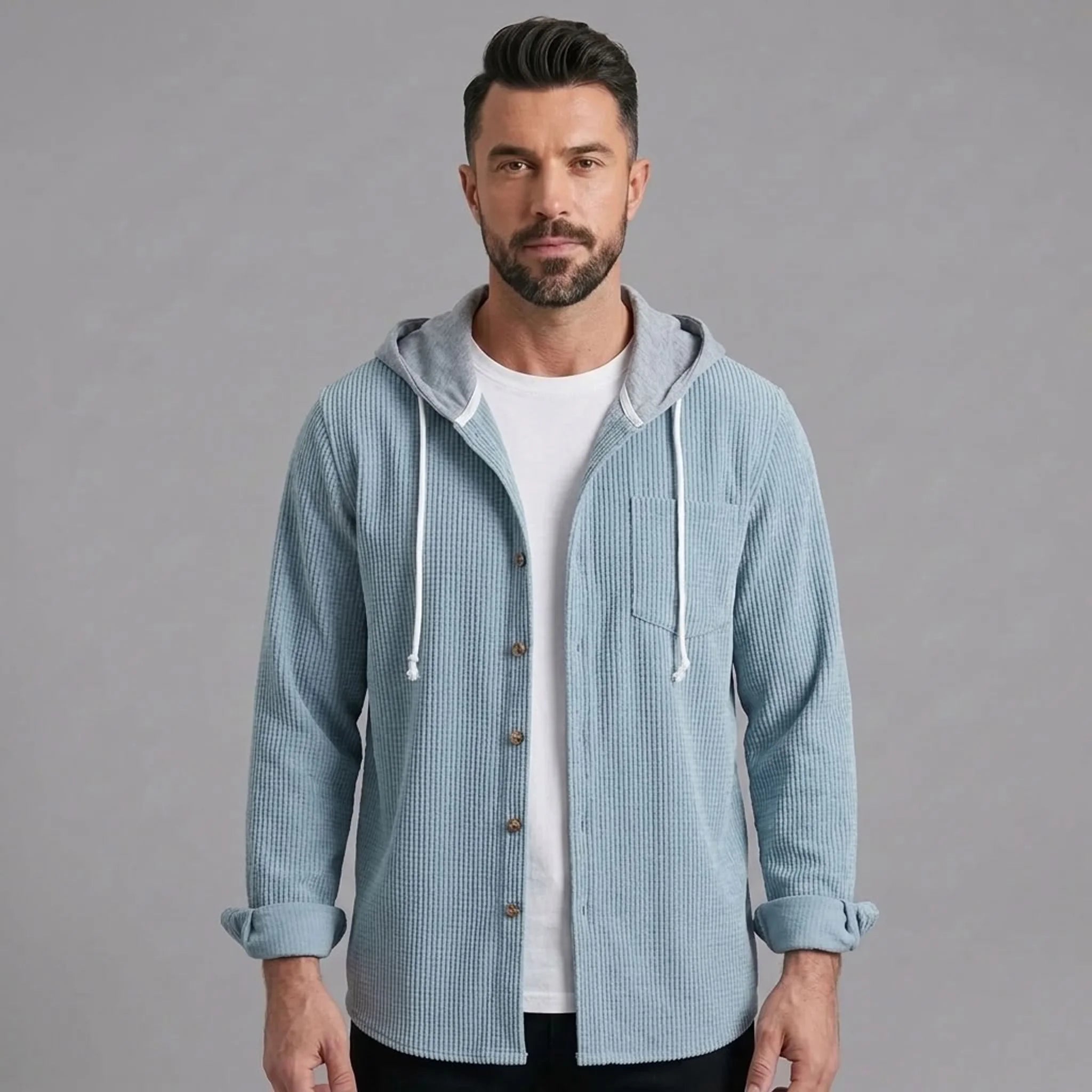 Man wearing light blue corduroy hooded shirt jacket, front view