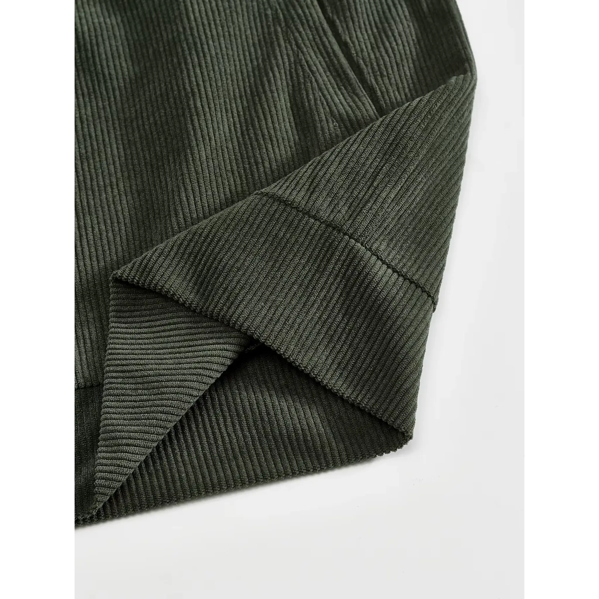Army green corduroy jacket close-up of hem and side seam